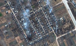 Maxar satellite imagery reveals burning homes and impact craters in Rivnopillya, Ukraine, on Feb. 28, 2022.