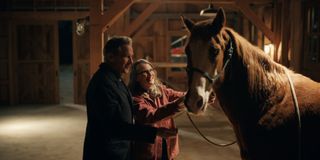 Tim Matheson as Doc and Annette O'Toole as Hope McCrea, petting a horse, in episode 602 of Virgin River.