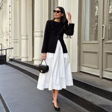 @babba wearing a white skirt and blazer