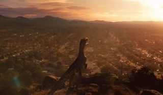 a velociraptor overlooking a housing development in Jurassic World: Fallen Kingdom