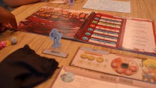 The Freelancers book, tokens, and dice on a wooden table