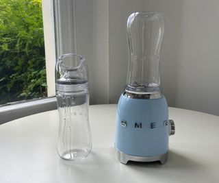 Smeg personal blender on its own on a white surface