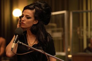 Back To Black is a movie that follows the tumultuous life of singer Amy Winehouse, played by Marisa Abela.