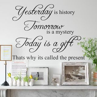 white room with wall quote and pictures