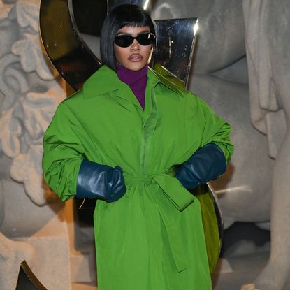 Teyana Taylor wearing a short bob haircut, a purple turtleneck sweater and a green jacket. 