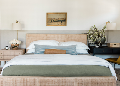 A neutral bedroom with a low profile headboard