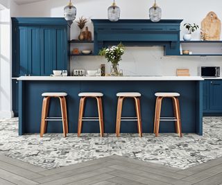 blue kitchen with grey wooden plank vinyl flooring intersected with diagonal planks in tile effect vinyl flooring