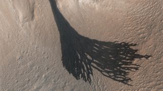Dark "slope streaks" on Mars formed by dust avalanches, as seen by NASA's Mars Reconnaissance Orbiter in 2017.
