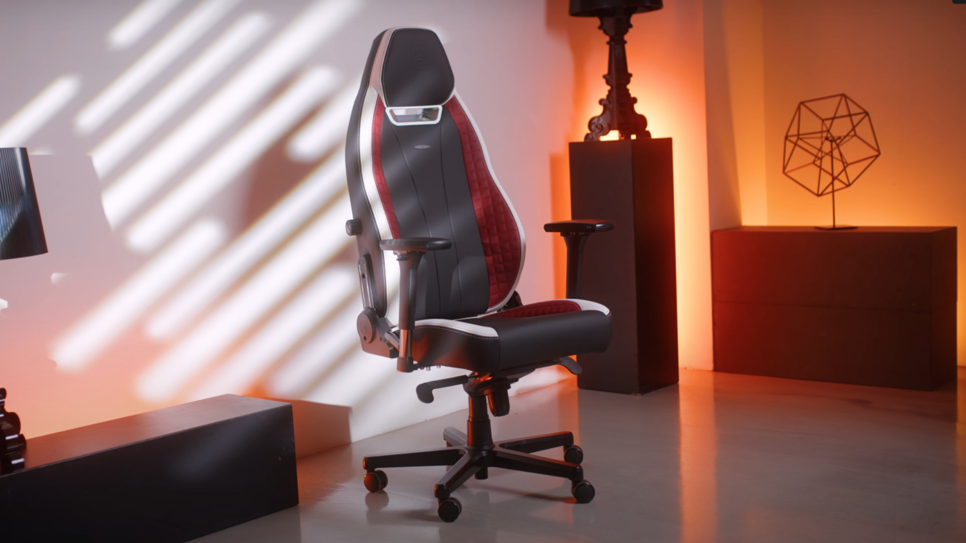 The Noblechair Legend gaming chair in a strangely lit room.