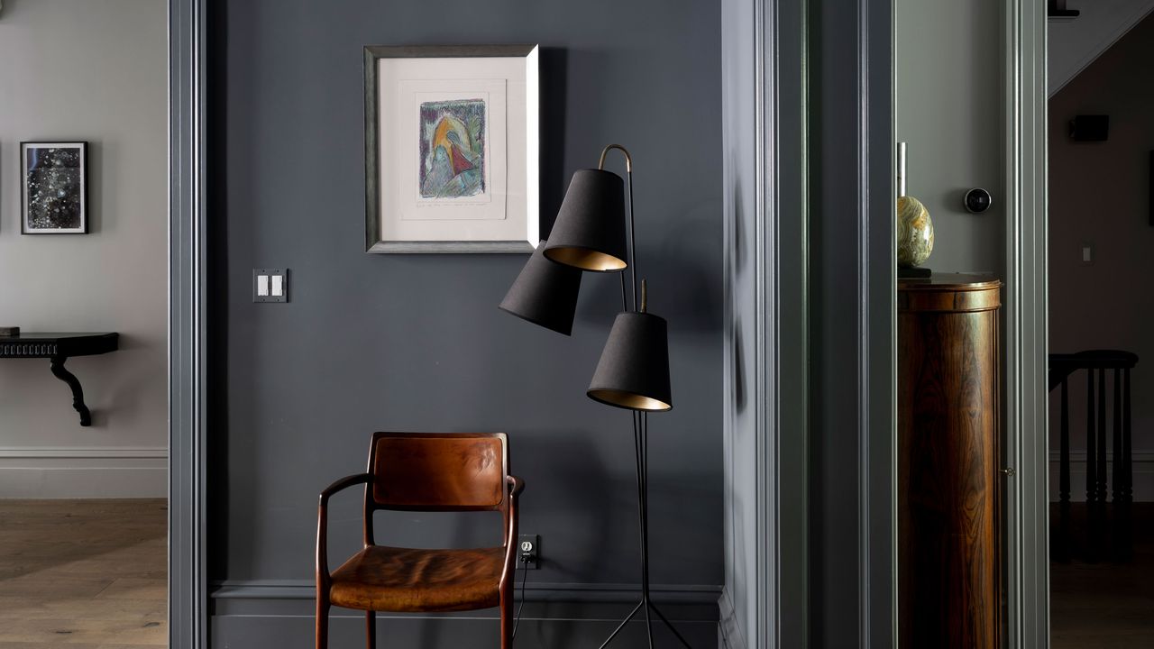 Living area with leather armchair and floor lamp with walls painted Farrow &amp; Ball Down Pipe