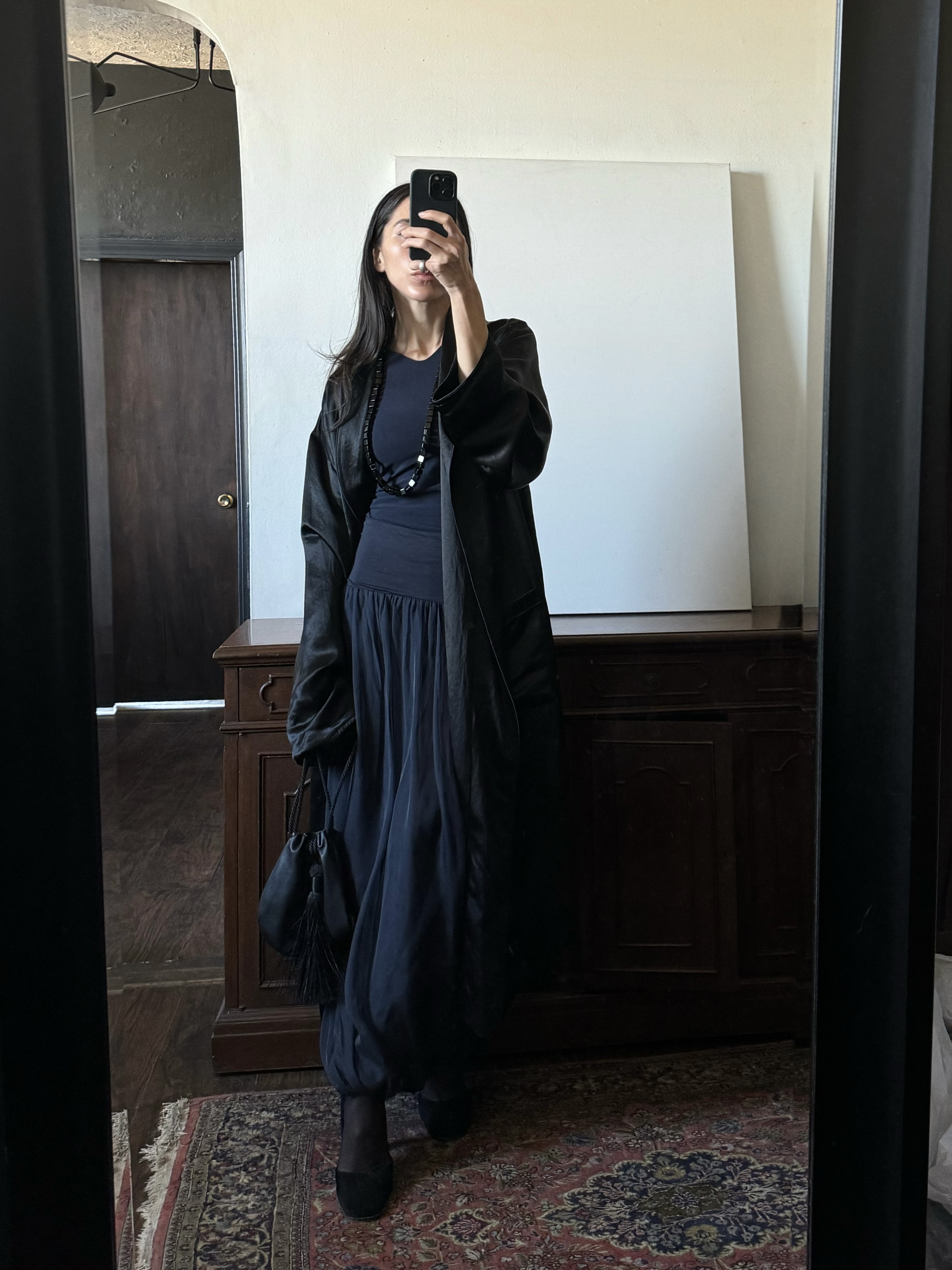 Alexis Badiyi wearing a robe and a skirt