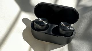 The Technics EAH-AZ80 true wireless earbuds in their charging case on a white background