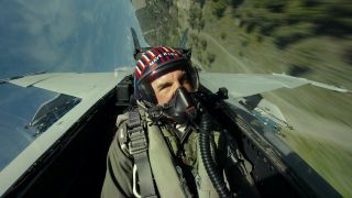 Helmeted Tom Cruise flying fighter plane in Top Gun: Maverick