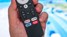 Netgem Pleio remote held in hand, showing Freely and Netflix buttons