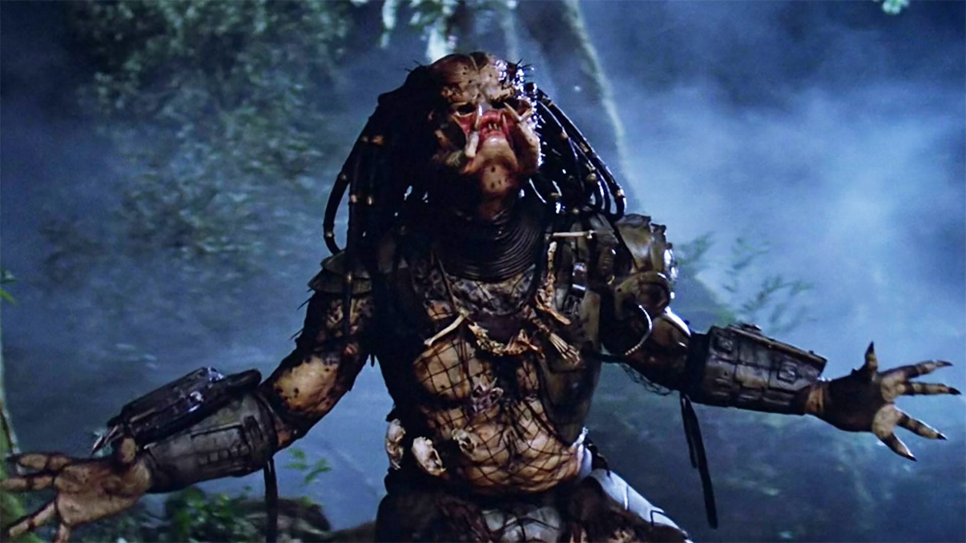 The Yautja hunter howling and baring its mandibles in 1987's Predator