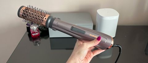 The BaByliss Air Style 1000 with the barell bruish attached being held in a hand