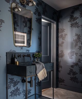 bathroom with dark vanity and walls