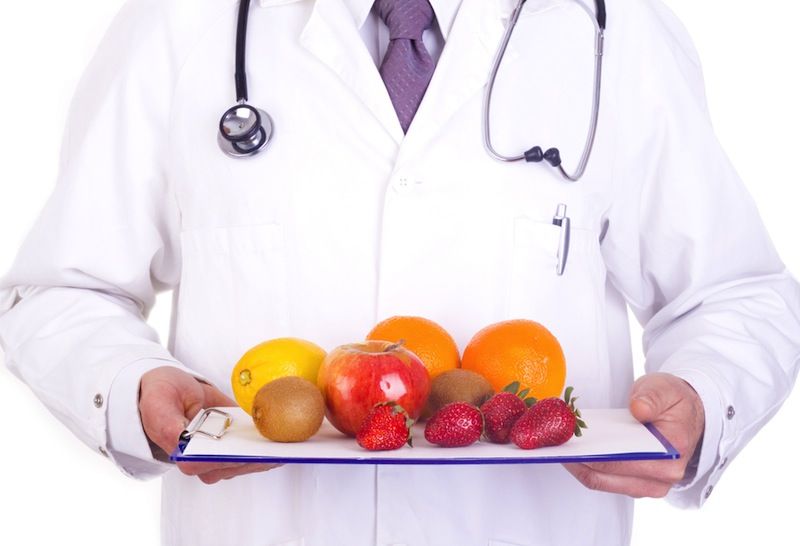 A doctor holds a tray of fruit