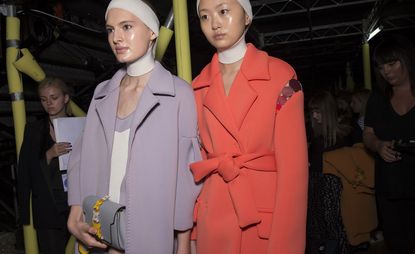 Models in Leather trimmed neoprene coats, cast in a rainbow of pastel hues