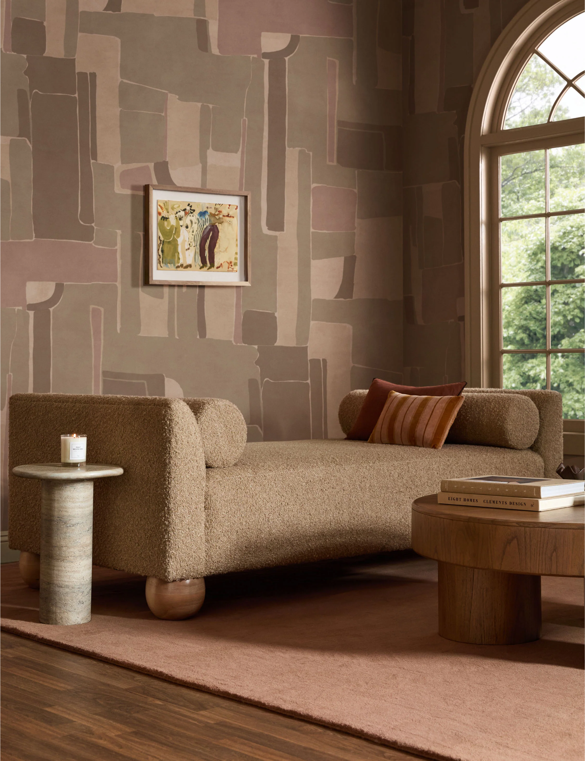 Art-forward living room featuring a ball-footed chair and a neutral wallpaper mural