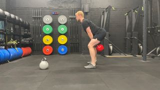 TechRadar fitness writer Harry Bullmore performing a kettlebell swing