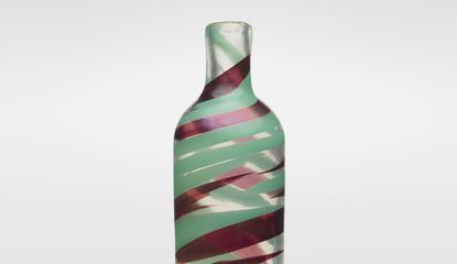 A glass vase by Carlo Scarpa with green and red swirls of color. 