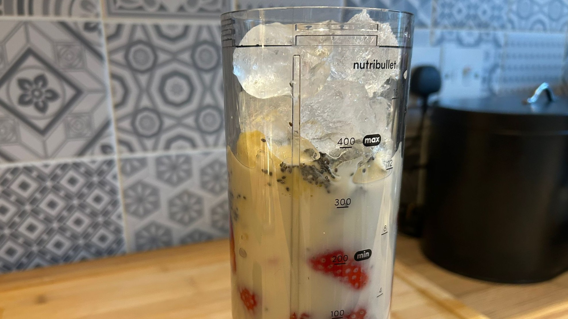 Nutribullet Flex blender containing strawberry banana smoothie ingredients