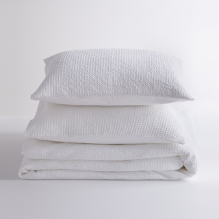 A white waffle bedding set folded and stacked