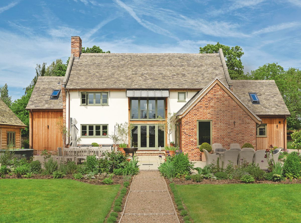 An oak framed self build property approached by a garden path