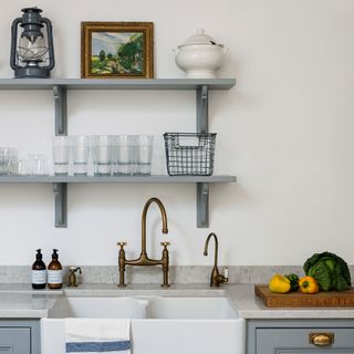White kitchen with open shelving over sink