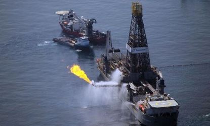 A flare burns from a ship recovering oil from the BP oil spill.