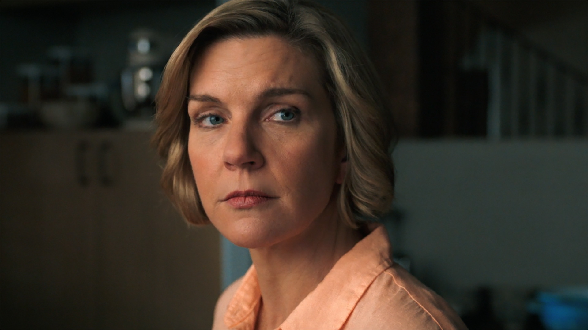 A close-up of Carol Sturka standing in her kitchen in Pluribus episode 8