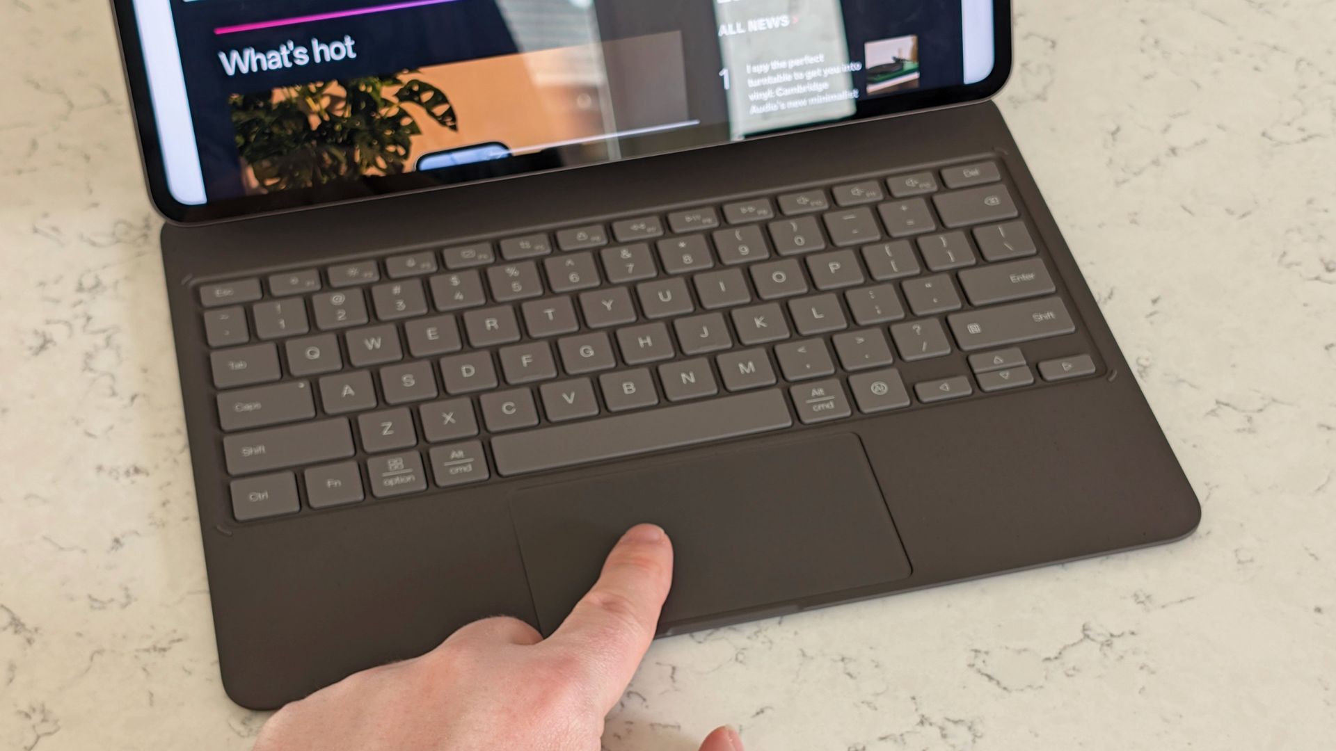 A finger on the touchpad of the Smart Keyboard Case