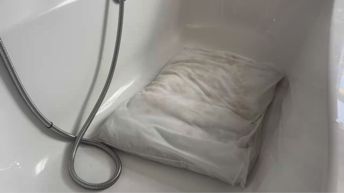 A stained pillow after being cleaned with baking soda.