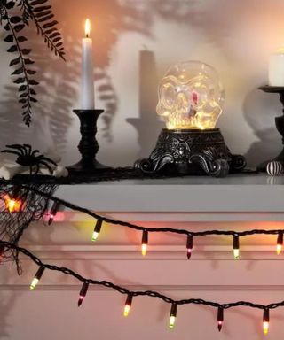 Halloween Mini String Lights on a mantel against a white wall.