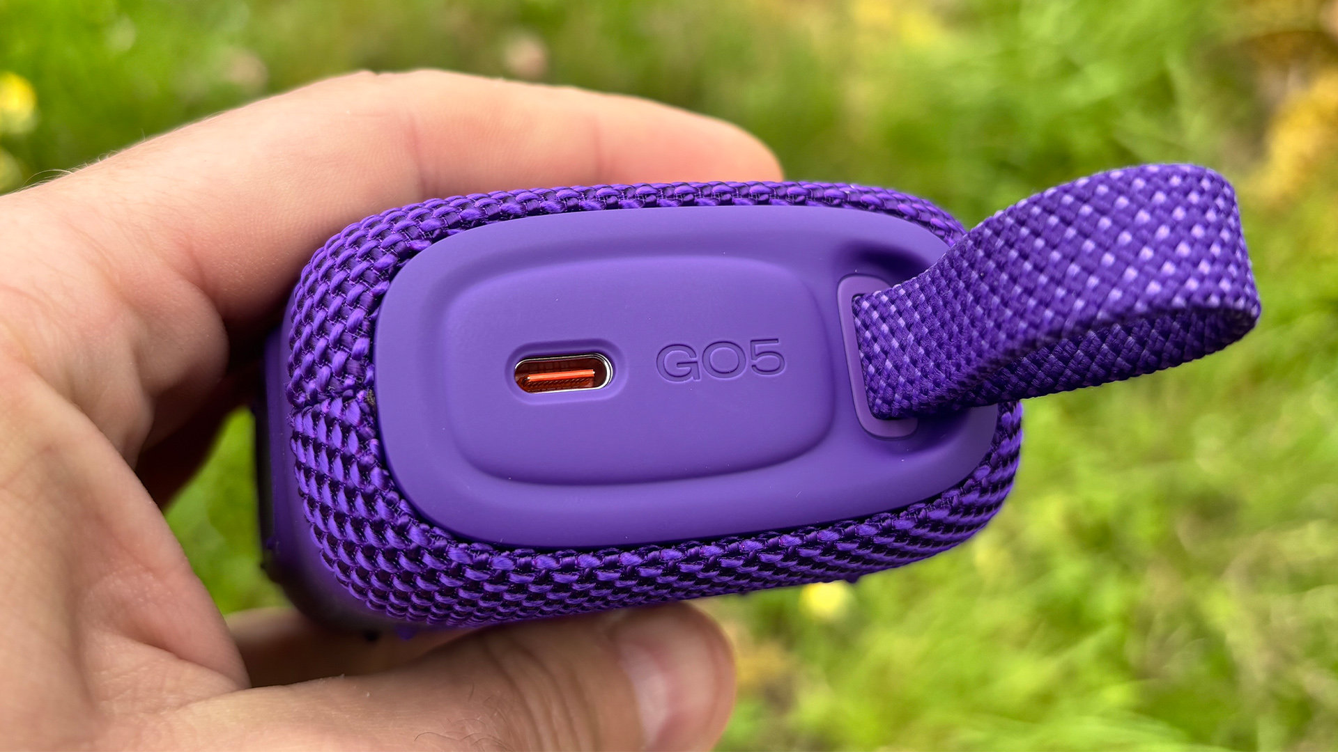 JBL Go 5 speaker in purple finish, close-up of USB-C charging port