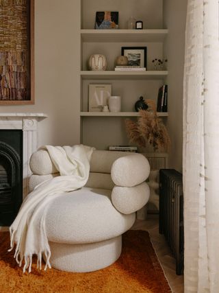 A living room with boucle accent chair