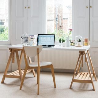 wooden table chair with white window and laptop