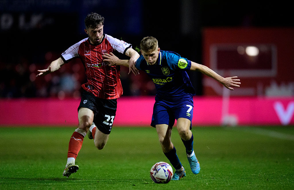 Callum Marshall in action for Huddersfield, holding off Lincoln&#039;s Sean Roughan