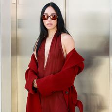 an influencer wears burgundy sunglasses by Ferragamo