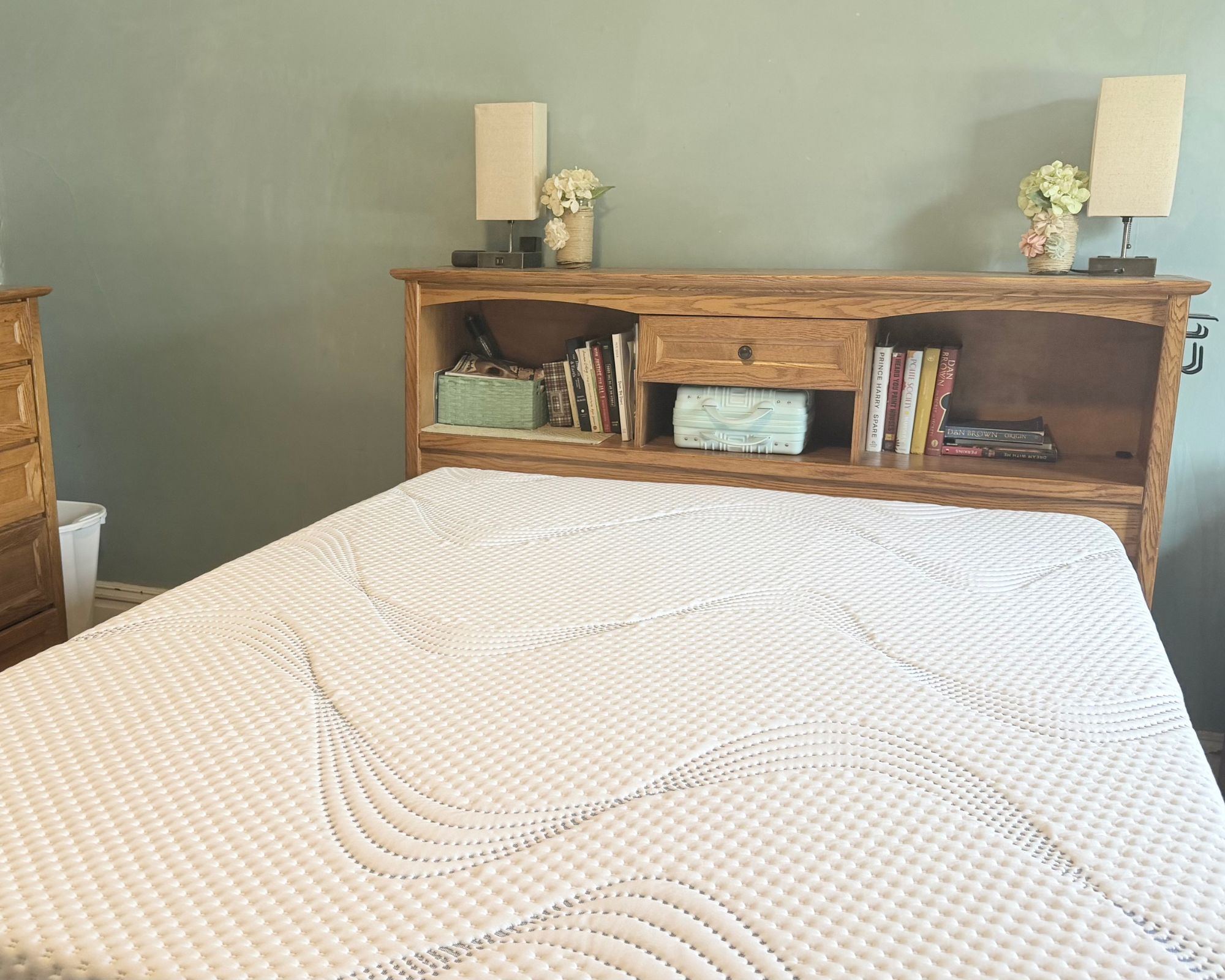 ComfortNext mattress in a blue bedroom with a wooden library headboard with books and a wooden dresser