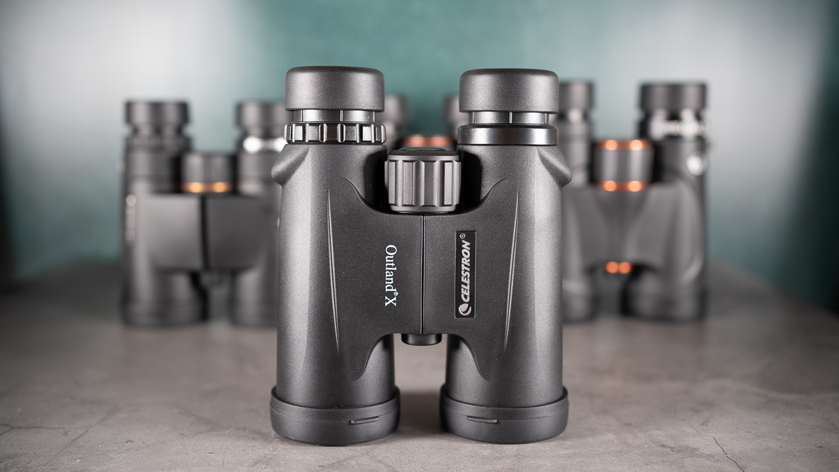 Celestron Outland X 10x42 binoculars against a dark background