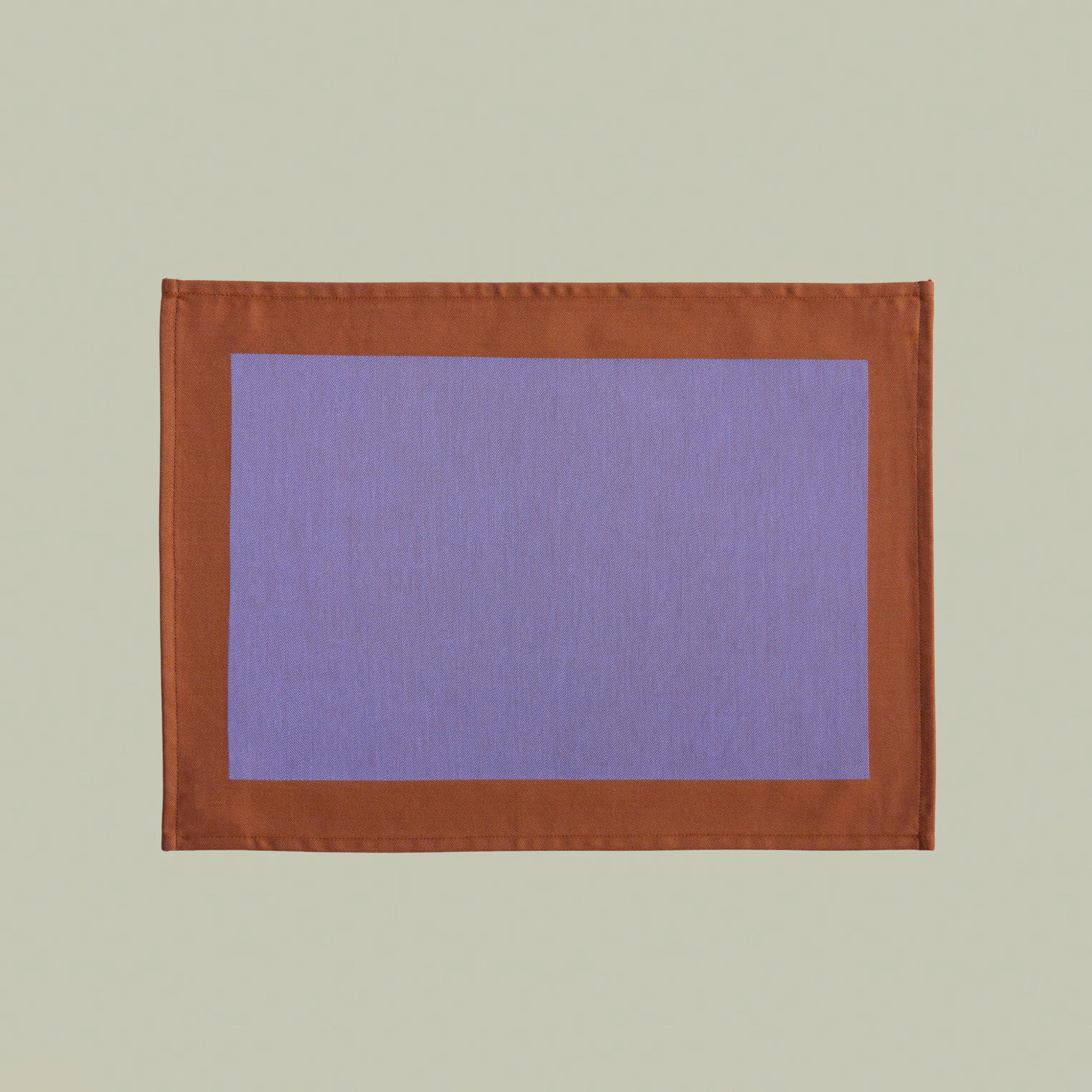 A lavender placemat with an orange border