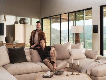 Nate Berkus and Jeremiah Brent in a neutral living room 