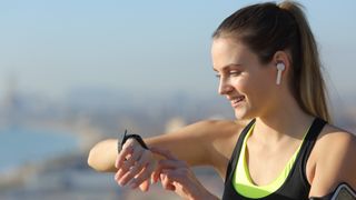 Happy woman checking GPS sports watch