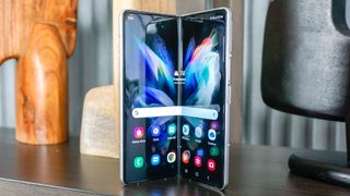 Samsung Galaxy Z Fold 3 open and standing on a desk
