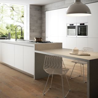 white kitchen with off white worktops and wood floors