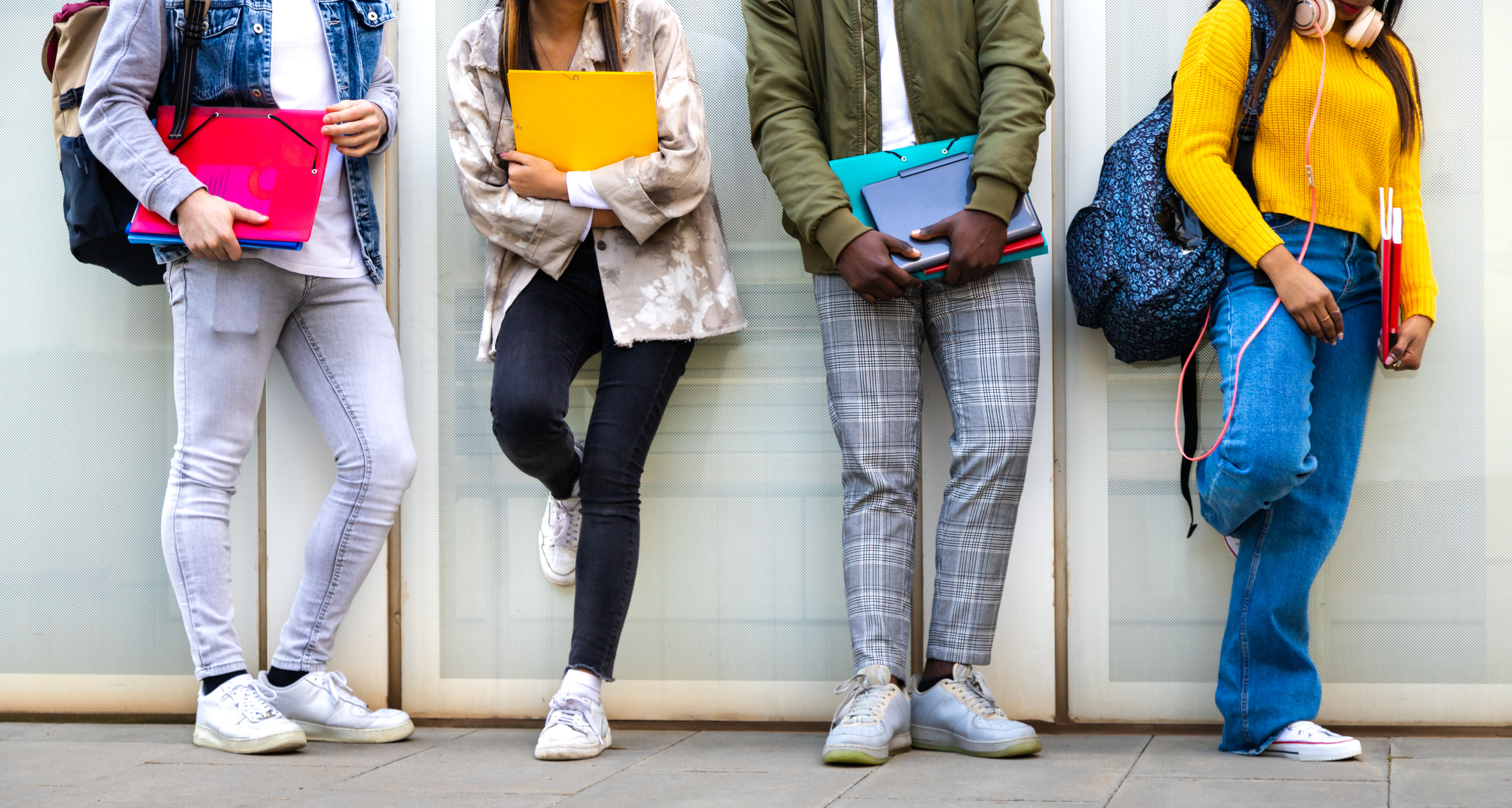 University students holding books and files
