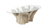 A garden table made from a large tree trunk base and glass table top
