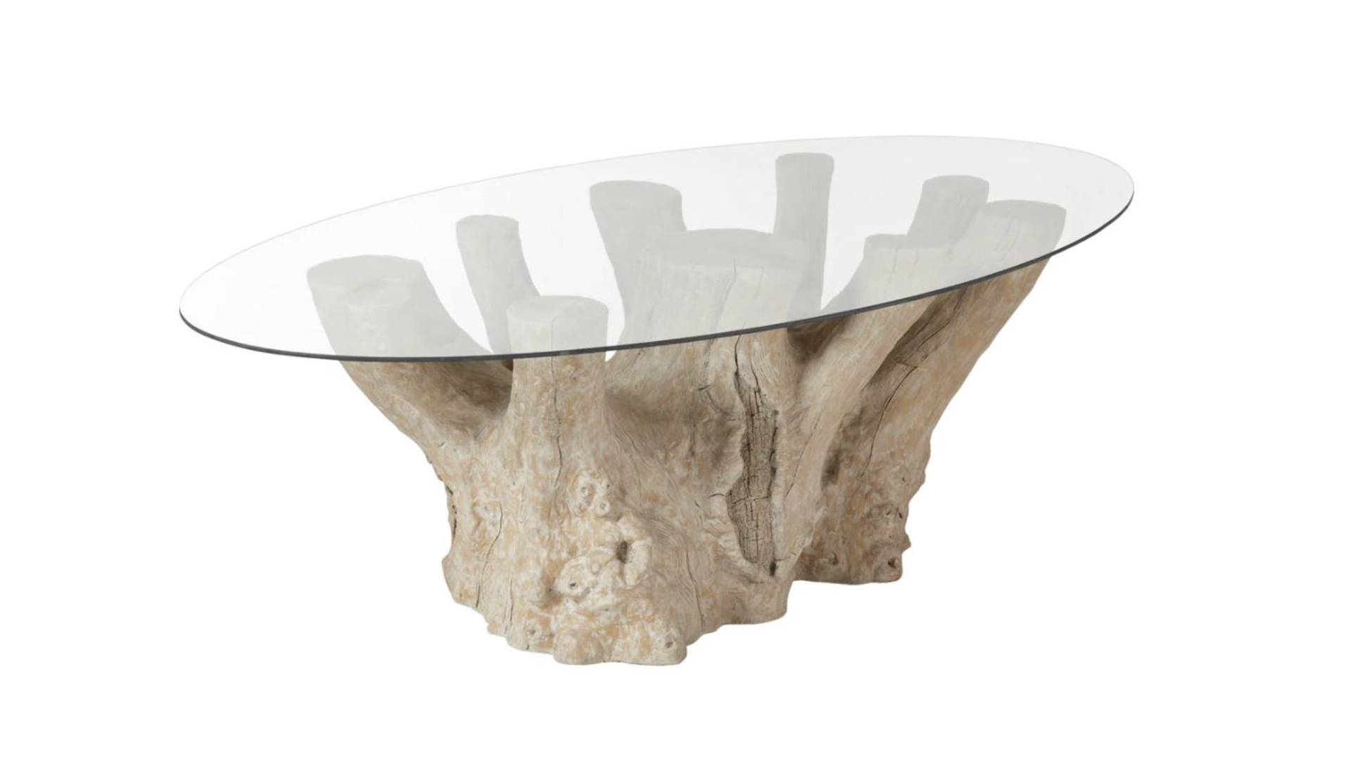 A garden table made from a large tree trunk base and glass table top